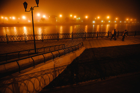 街道夜里在雾的深城市风景中在照片的雾横跨城市河桥镇晚上图片