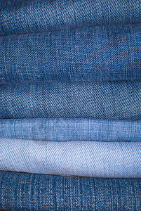 穿材料织物Jeans背景蓝色不同形状中JeansTrousers的堆叠图片