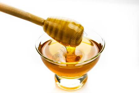 毛雨蜜糖养分蜂在玻璃碗里用木棍图片