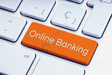 银行业互联网在线的橙色计算机键盘上的在线银行词图片