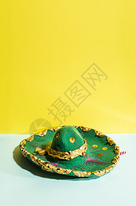 蛋黄酱几何色和绿柔调背景上的墨西哥草帽带墨西哥装饰品和的绿色帽子稻草墨西哥人图片