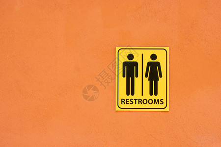 橙色墙上的厕所标志白色黑信息图片