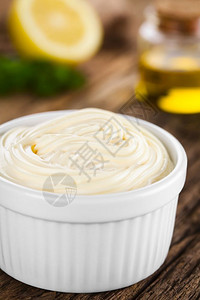 蛋黄酱在白碗里面粉柠檬和油在后面的选择焦点中聚在蛋黄酱中间调味品传播脂肪图片