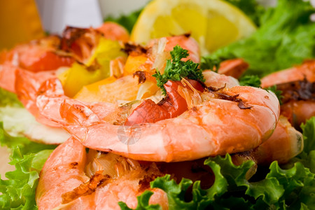 烹饪甲壳类动物相片照美味的烤虾在配有肉桂蛋白的生菜床边胡椒图片