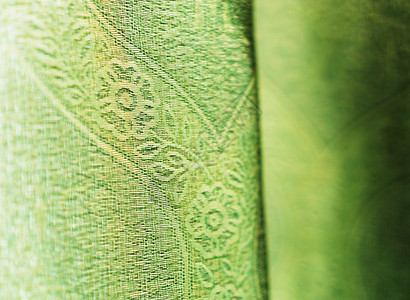 介绍作品垂直鲜艳的绿色织物散景背垂直的鲜艳绿色织物散景背空白的背景图片