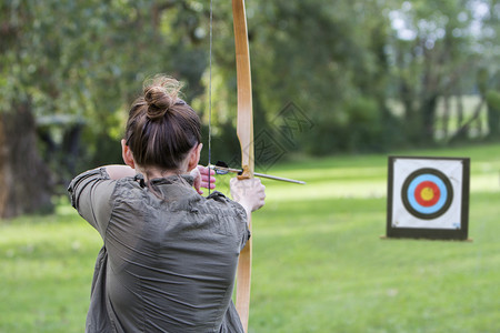 射箭女孩弓箭手使用和头向目标背景图片