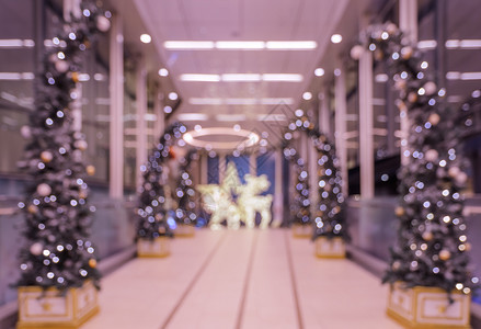 办公室旅馆前厅或购物中心室内建筑的模糊抽象背景带有明灯的圣诞树光芒照亮或者模糊的大堂图片