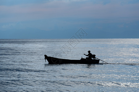 黄昏时在海上的渔船航平静洋图片