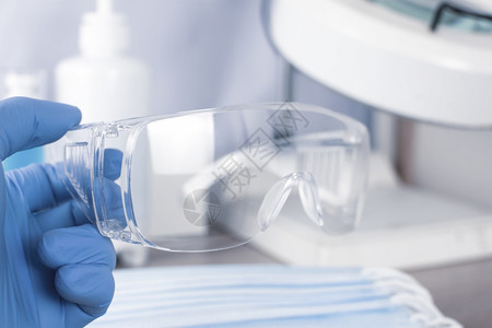 实验室保健工作人员手握的保护眼戴目镜保持专业的科学图片