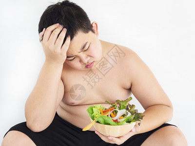 一种个胖男孩讨厌吃蔬菜沙拉亚洲人不开心图片