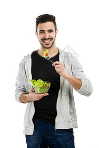 饮食英俊的营养快乐年轻人吃沙拉孤立在白色背景图片