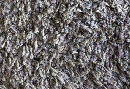 优雅的家灰色棕羊毛地板毯关闭宏观背景纹理手工制作的图片