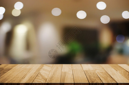购物中心桌上抽象的餐饮咖啡厅背景中模糊的夜光上空木板桌图片