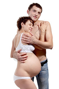 预期生活待年轻男人和怀着孕妻子的白人男图片