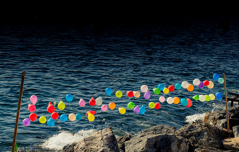 水气球夏天绿色为游戏而将气球挂在水上的绳子喜悦背景