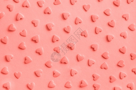 爱情浪漫图案粉色糖果心洒在背景质感珊瑚色调粉糖果心洒在质感珊瑚调装饰风格面包店生日图片