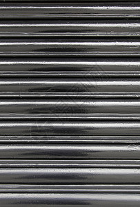 外部的银黑色金属墙彩金属墙的详情闪亮纹身背景在城市中抽象的背景图片