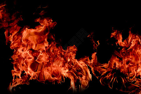 夜晚热的美丽抽象艺术黑色背景的火焰燃烧红色热火花上升烈橙光闪耀的飞行粒子图片
