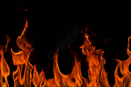 抽象艺术黑色背景的火焰燃烧红色热火花上升烈橙光闪耀的飞行粒子壁炉发光的黄色图片