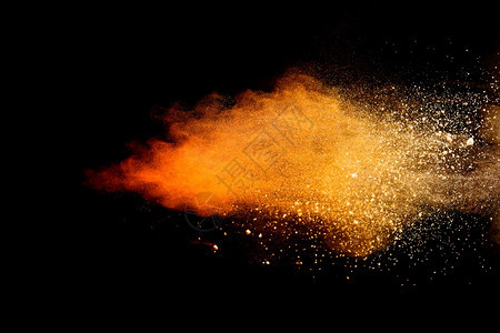 飞溅橙色粉末在黑背景下爆炸的冷冻运动画有毒的图片