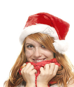 脸一位快乐的年轻红发女人肖像带着圣诞老人的帽子肖像一个快乐的年轻红发女人喜悦季节充满活力图片