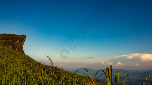 草山上高悬崖在日落时向天空倾斜美丽景观图片