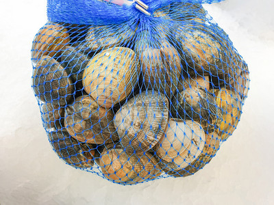冰上袋子里的新鲜生胡桃的鹌鹑贝类图片