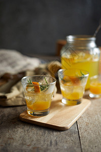 混合苏打含迷迭香的旋转橙色鸡尾酒桌子图片