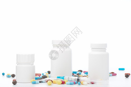 瓶子白色药丸和背景的彩药丸白塑料瓶和白色背景的彩药丸科学垂直的图片