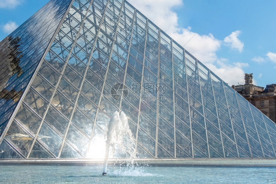 法国巴黎阳光明媚的日子卢浮宫庭院的玻璃金字塔和喷泉特写卢浮宫庭院的玻璃金字塔和喷泉晴天历史象征图片