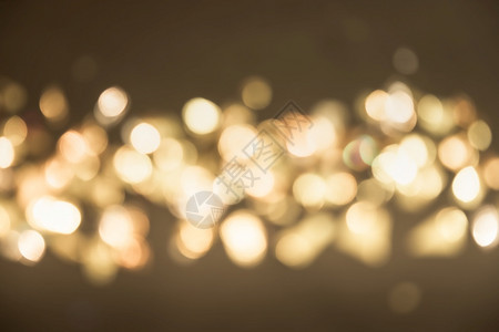 金光圣诞节日会背景摘要闪亮与bokeh的金色亮光相交织划痕派对辉光图片