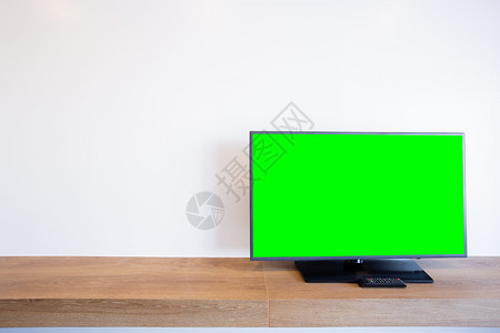 小样空的在砖墙室内房绿色屏幕上播放显示器引导的电视或桌子图片