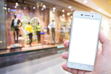 里面电话男子在商场使用智能手机模糊图像如背景象信息图片