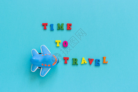 运输象征问候彩色文本时间旅行和儿童有趣的玩具飞机在蓝纸背景复制空间顶视图概念旅游模板为明信片贺卡彩色文本时间旅行和儿童有趣的玩具图片