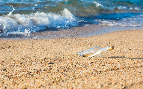 水瓶里有信息在海滩岸边的蓝色帮助寂寞图片