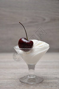 在玻璃碗里一勺冰淇淋上只樱桃可口食物有机的图片