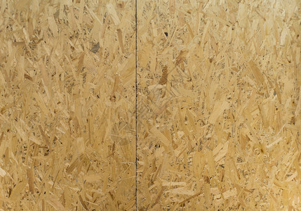 质地浅褐色的木头OSB板由棕色木屑制成砂背景OSB体底图片