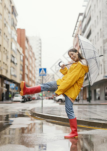 微笑妇女有雨伞站在前视线常设站立图片