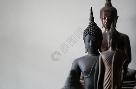 排金子树在其他佛祖雕像中间的古老黑色代佛教雕像的选定焦点图片