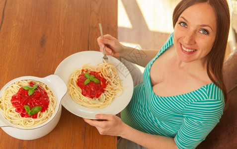 孕妇用番茄酱吃大部份意利面粉的相片厨房可口在室内图片