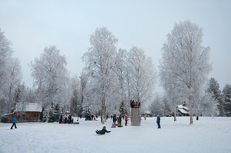 下雪的白色地区孩子们在露天空气博物馆的冰滑中骑着儿童在俄罗斯阿肯汉格尔克附近的MalyeKorely图片