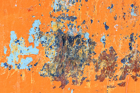 质地铁风化橙色金属背景有破碎剥皮涂料含蓝油漆和生锈点的污渍图片