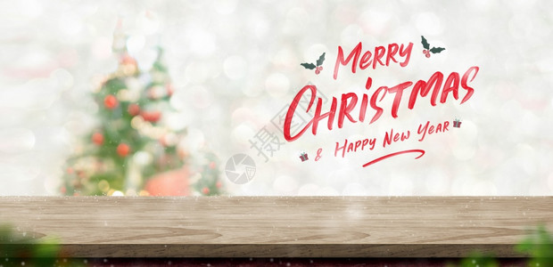 圣诞快乐和新年文字在木板上方的材桌顶模糊bokehxmas树装饰庆祝为了手写图片