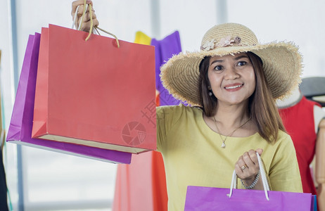 衣服女孩一名高级亚洲女设计师展示多彩的纸袋销售和送货服装购买图片