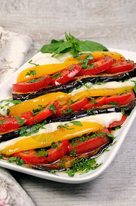 一顿饭调味料含西红柿黄胡椒和切片莫扎里拉的烤茄子食物背景图片