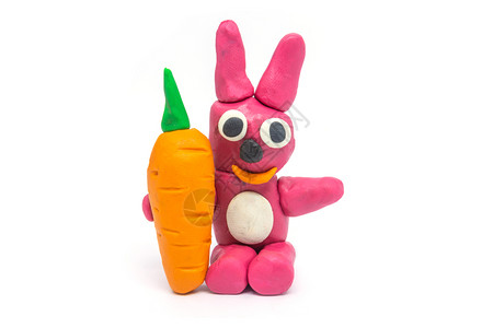 黄色的花面兔子在白色背景上握着胡萝卜模型庆典图片