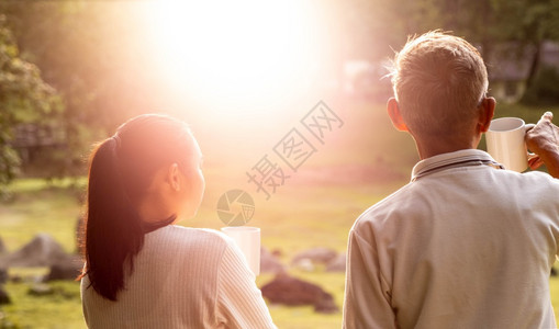 爱外孙女和祖父的近视他们在外面喝热咖啡在山上度假时享受风景清晨阳光照耀天空热的图片