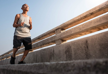 陈年亚洲运动队高长男子在天上桥慢跑健康生活方式和保健概念包括拉伸跑步图片