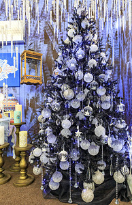 冬天更新快乐的银星圣诞球胸罩装饰冰棒的集合由明灯照亮在苗条圣诞树上的一串银星圣诞玩具和星圣诞罐子装饰冰棒和挂在圣诞树上的蓝灯图片