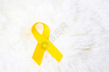 黄色背景上的丝带预防疾病概念背景图片
